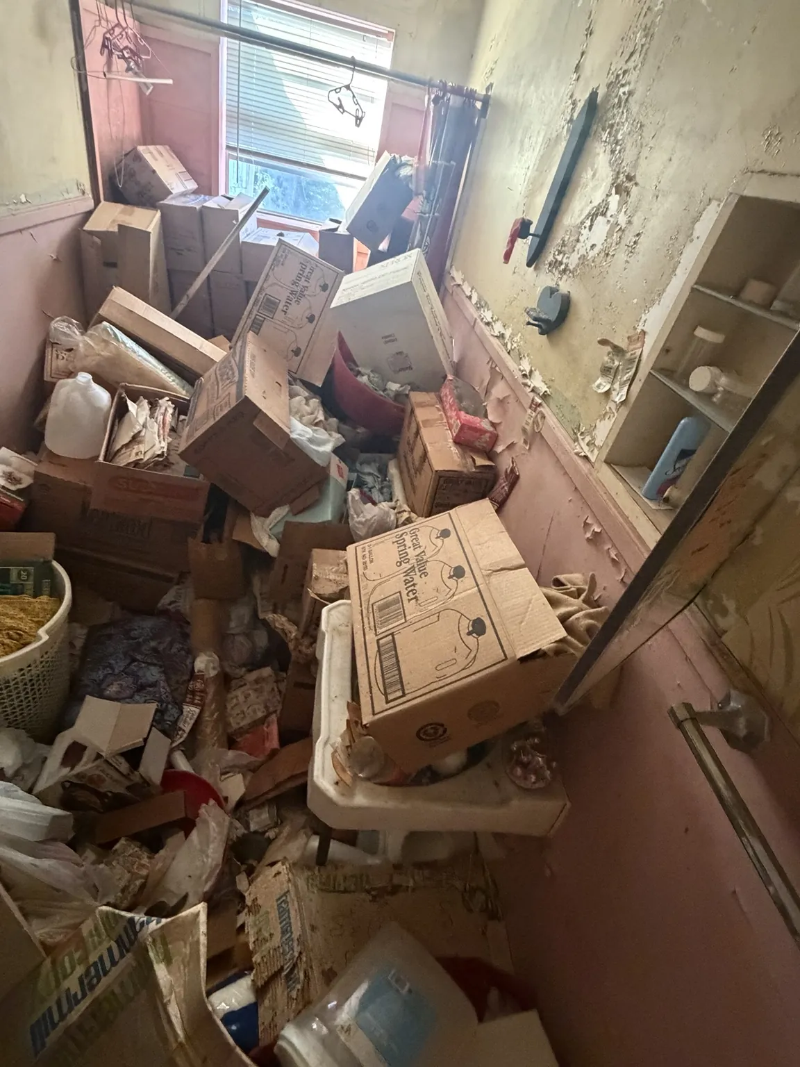 Bathroom with boxes and household items awaiting cleanout