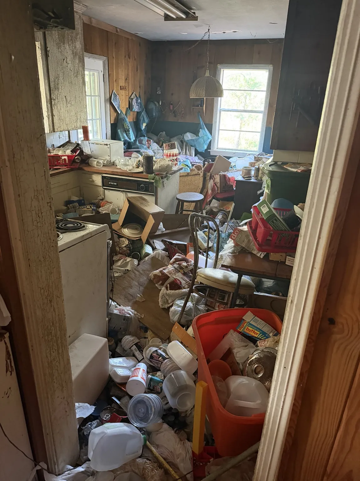 Room crowded with bins, bags and loose household items