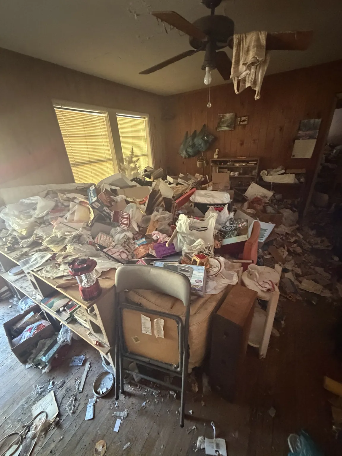 Furniture and assorted household items filling a living area before removal