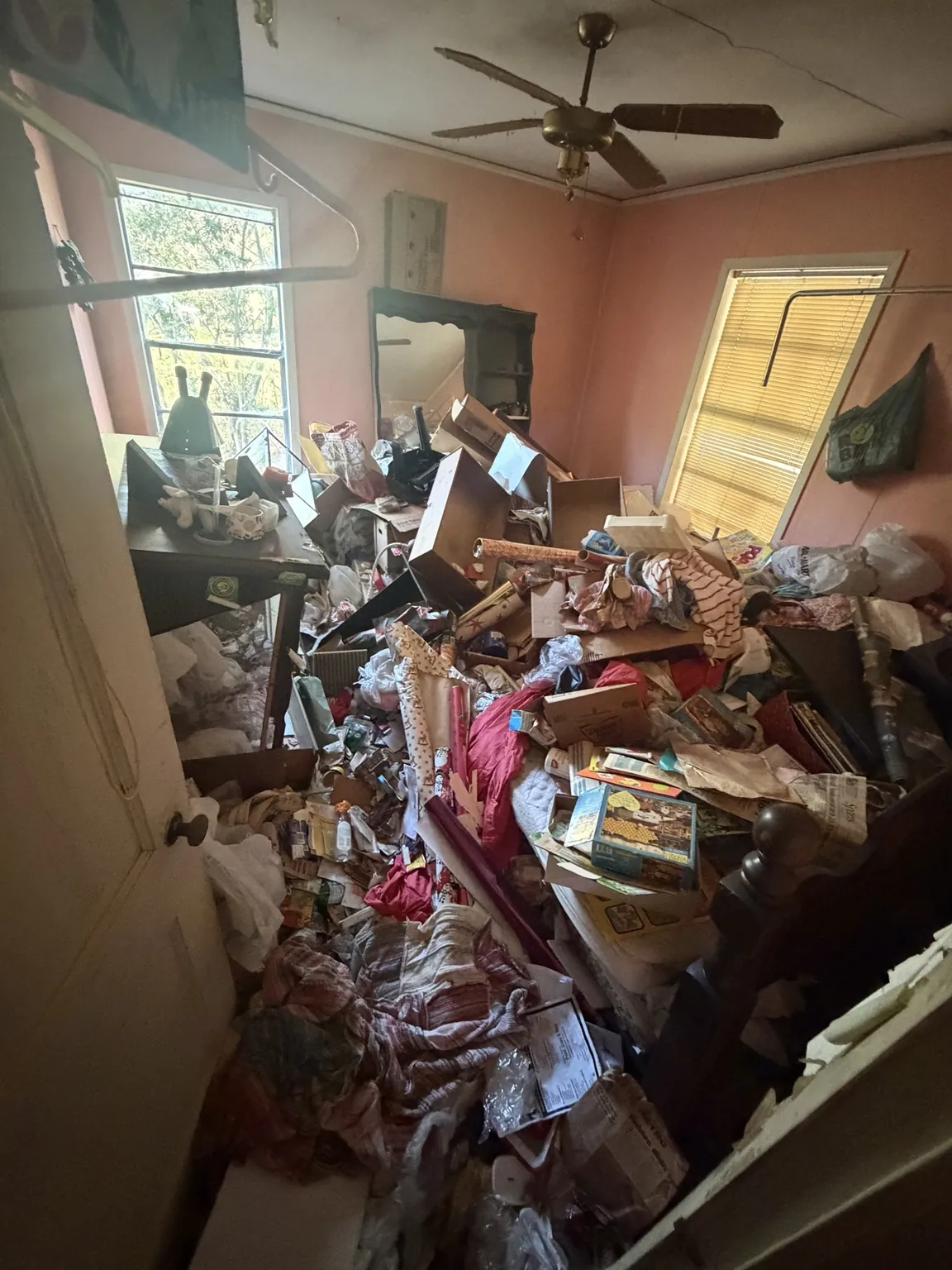 Furniture and loose household items in a Frisco property before an eviction cleanout