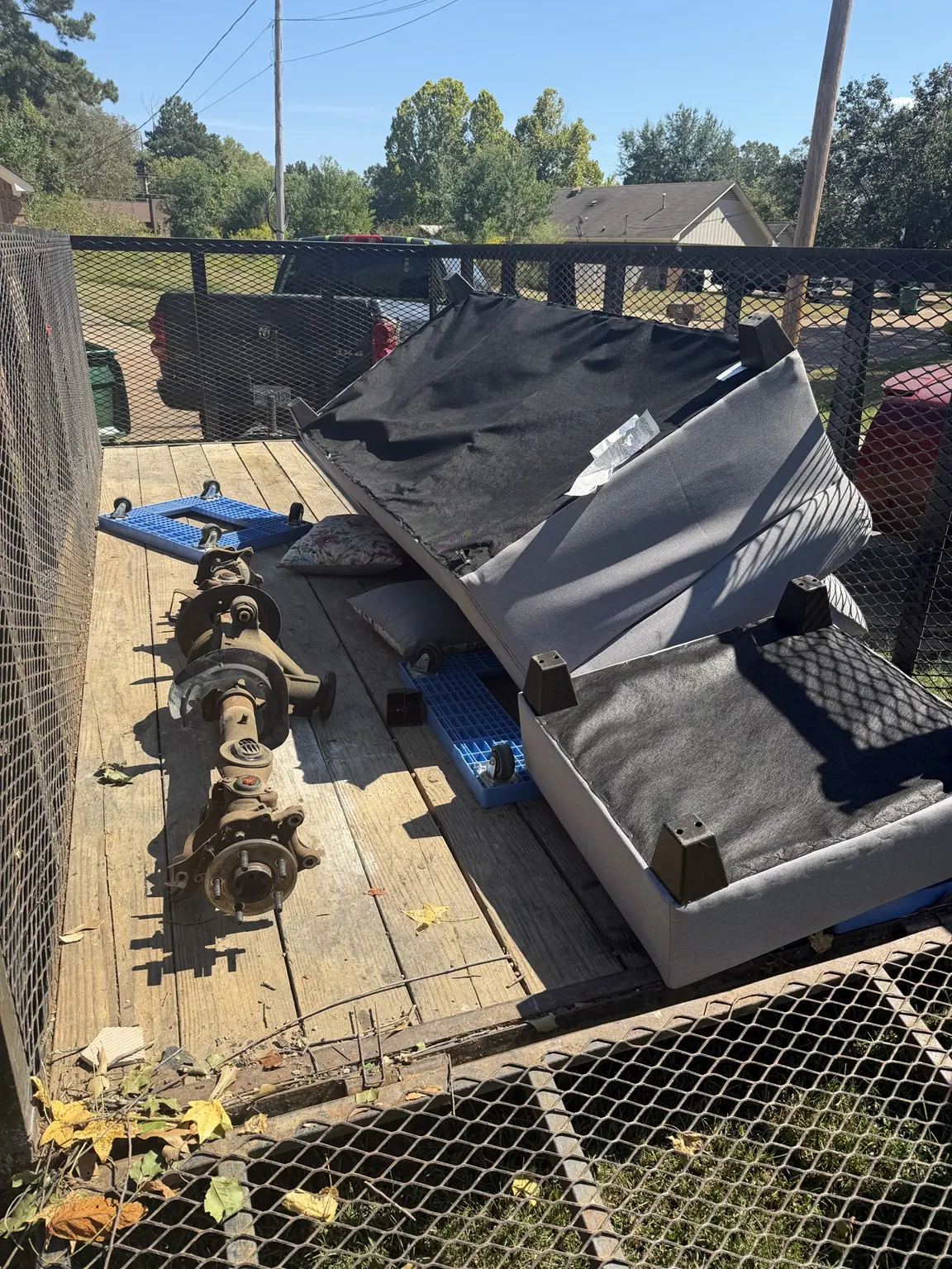 Bulky panels and metal components placed on a junk removal trailer