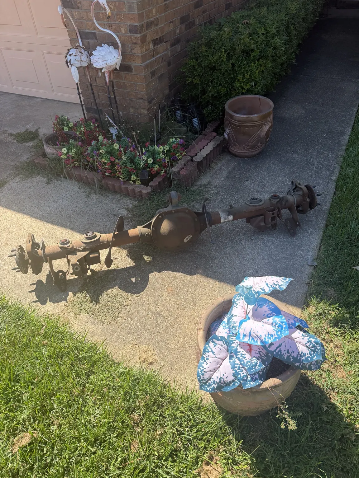 Heavy metal parts staged on a driveway for junk removal