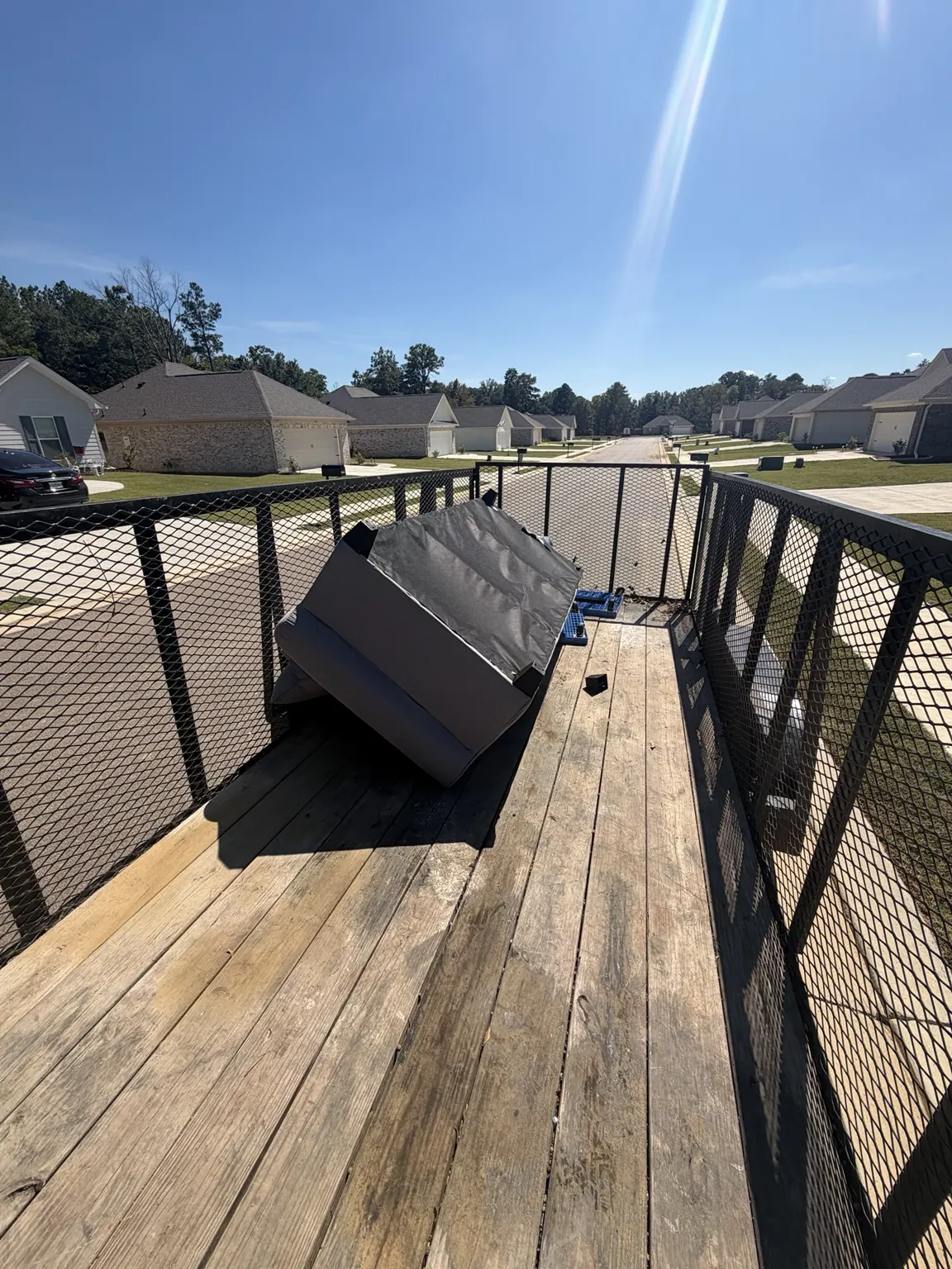 Bulky item placed in an open trailer during a Frisco pickup