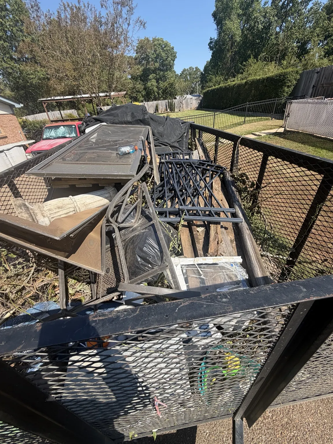 Another angle of the loaded trailer with metal frames and bulky items