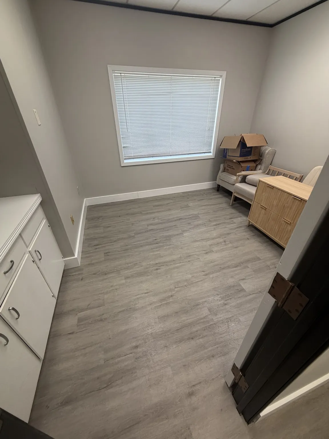 Wider view of the office after removal, with the main floor clear and some furniture still in place