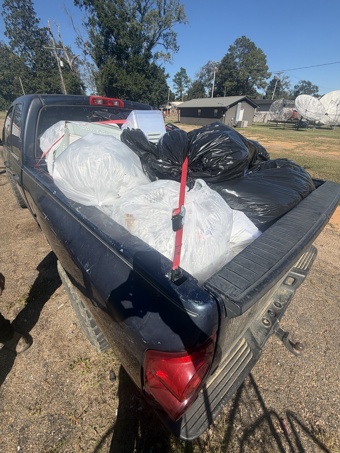 Bagged and boxed material loaded into the pickup truck at the property