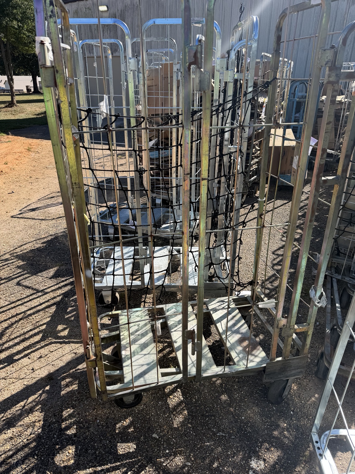 Rolling metal cart of material behind a retail store