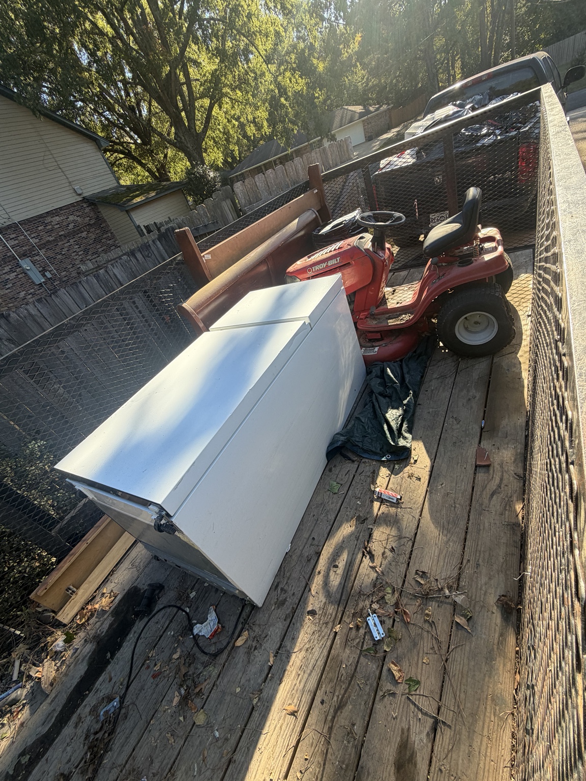 Freezer and other bulky items in a pickup bed after the job
